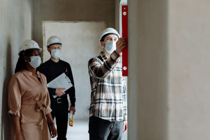 Construction team applying NEBOSH safety standards onsite