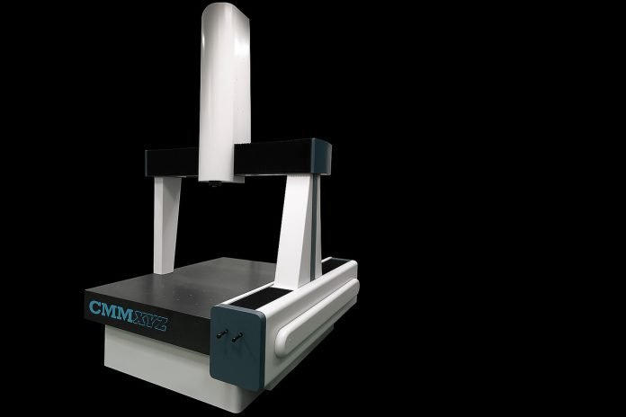 Landscape view of a CMM machine on a black background.