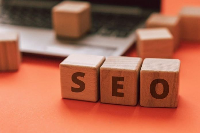What Growing Businesses Get Wrong When Choosing an SEO Partner Wooden SEO blocks on desk near laptop