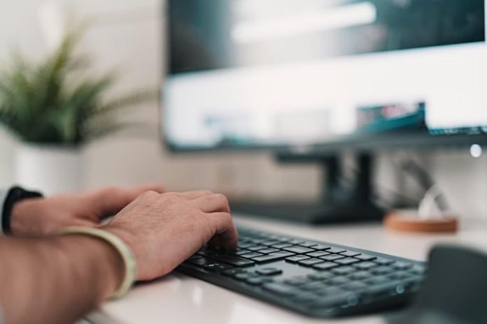 Hands typing on keyboard for AI Search SEO in 2026
