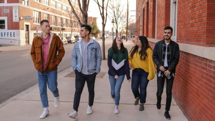 The Strange Pressure of Choosing a Life at Seventeen Group of teenagers walking together on a city street, laughing and enjoying a carefree moment while facing future life decisions